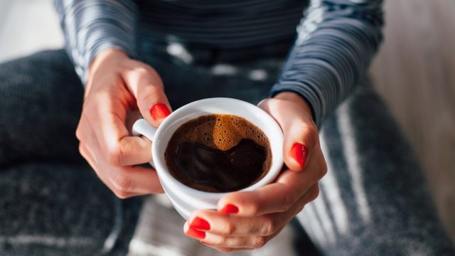 Woman holding cup of coffee