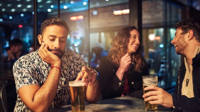 woman ignoring her date at the bar, talking to another man