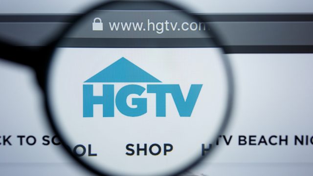 The HGTV logo on a laptop screen through a magnifying glass