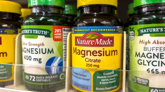 Bottles of magnesium supplements on a store shelf