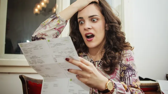 Woman shocked and surprised with her electricity bills