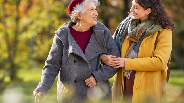 young woman walking in the park with her grandmother