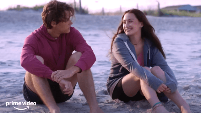 Still of Conrad and Belly sitting on the beach in The Summer I Turned Pretty